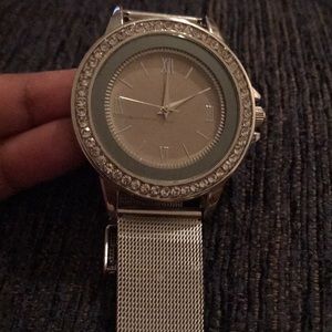 A platinum band and diamond watch.